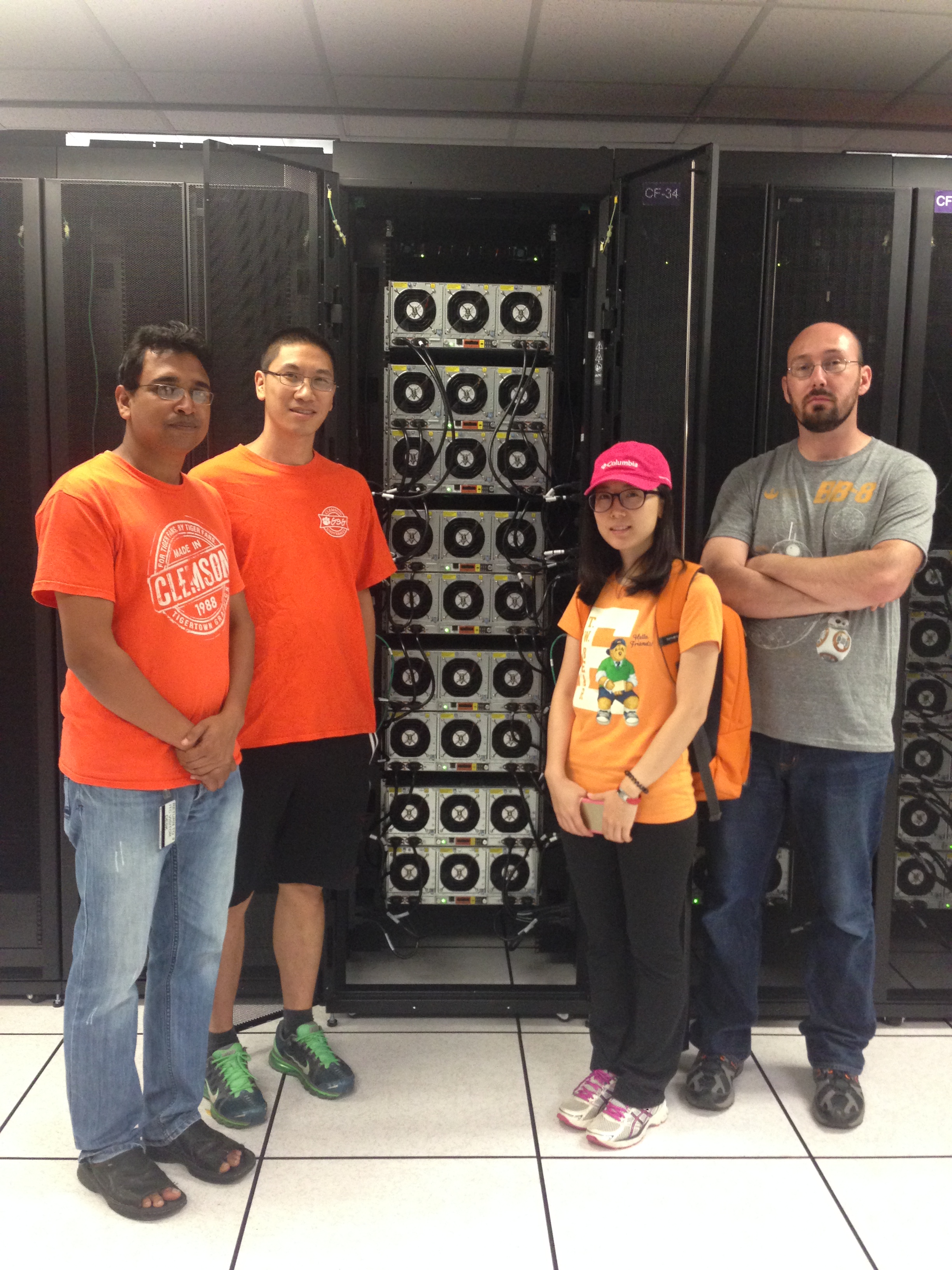 picture of students standing in from of computer center rack