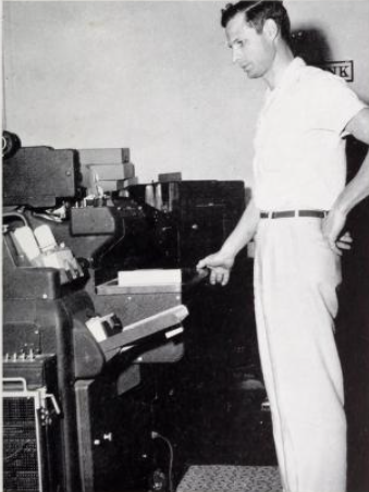 picture showing man running punched card equipment